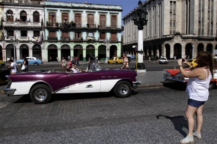 An Argentine tourist has his picture taken in a 1956 Buick in Havana. U.S. tour operators are excited over rules recently spelled out by the Obama administration that promises access to Cuba under educational and people-to-people exchanges. 